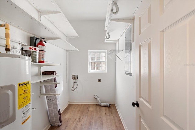 laundry area featuring water heater, light hardwood / wood-style floors, and hookup for an electric dryer