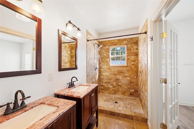 bathroom featuring vanity and tiled shower