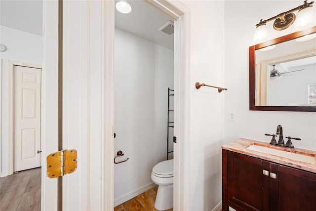 bathroom featuring hardwood / wood-style floors, vanity, and toilet