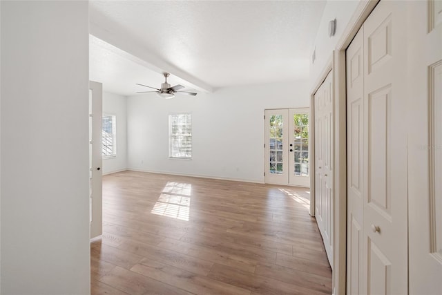 unfurnished room featuring ceiling fan, french doors, a textured ceiling, and light hardwood / wood-style flooring