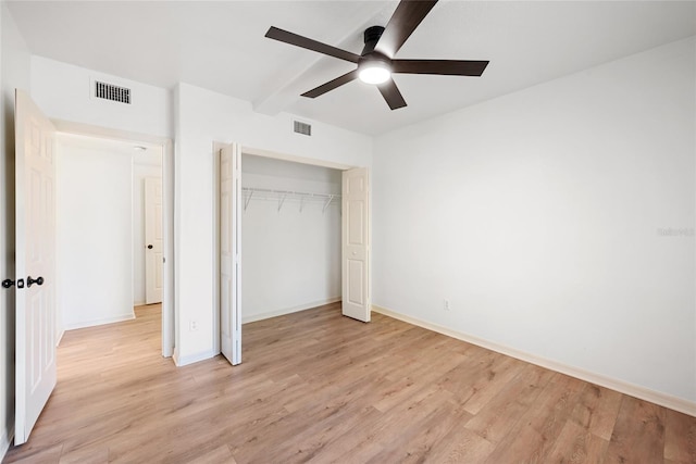 unfurnished bedroom featuring ceiling fan, light hardwood / wood-style floors, and a closet