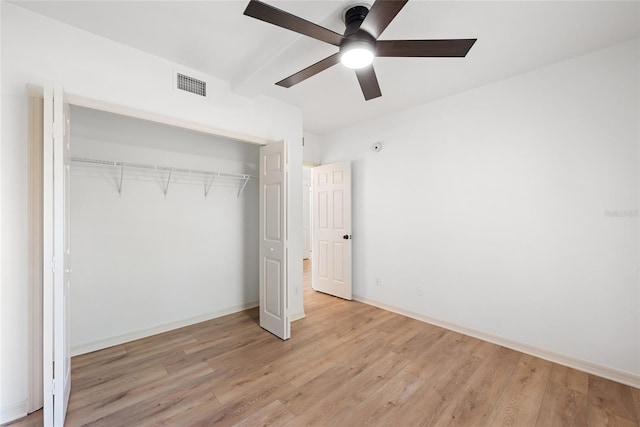 unfurnished bedroom featuring ceiling fan, a closet, and light hardwood / wood-style flooring