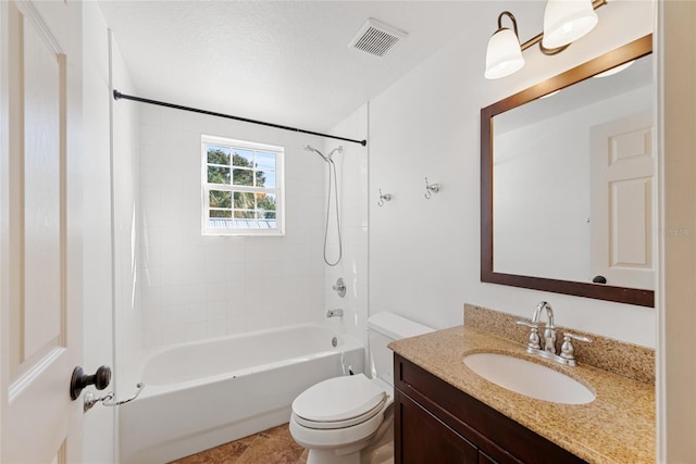 full bathroom with vanity, toilet, a textured ceiling, and tiled shower / bath