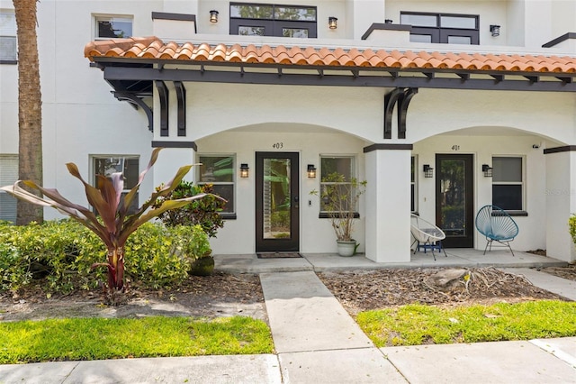 403 S Oregon Ave, Tampa, FL 33606 - property entrance featuring stucco siding, a tile roof, and covered porch
