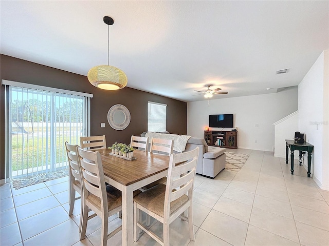 dining room with light tile patterned floors and ceiling fan