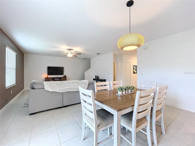 tiled dining space featuring ceiling fan