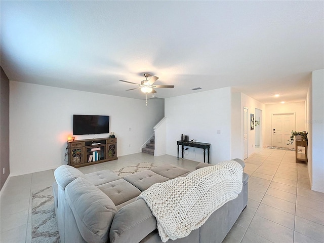 living room with light tile patterned floors and ceiling fan