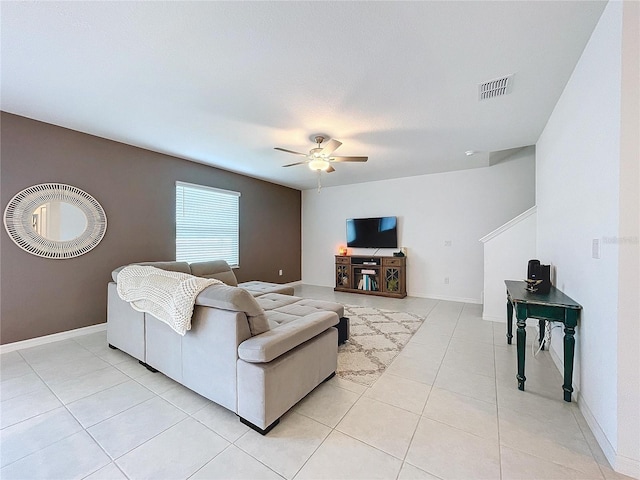 tiled living room featuring ceiling fan