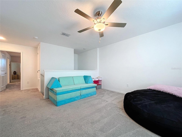 interior space with ceiling fan and a textured ceiling