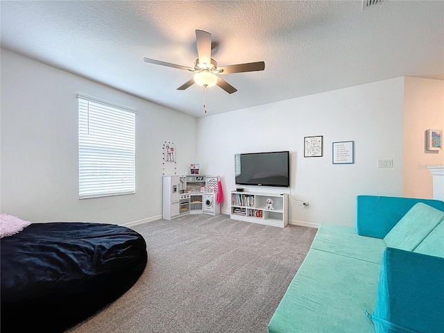 carpeted living room featuring a textured ceiling and ceiling fan