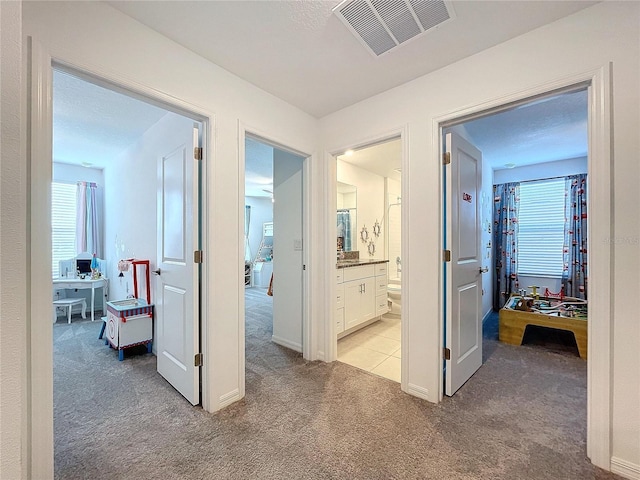 hallway featuring light carpet