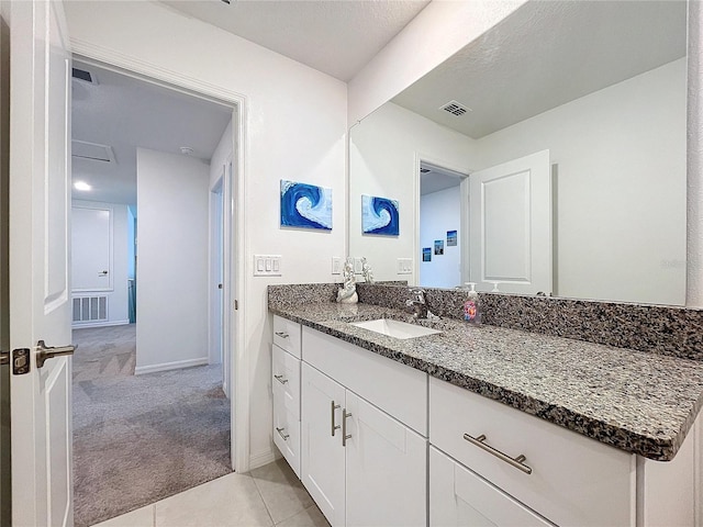 bathroom featuring tile patterned flooring and vanity