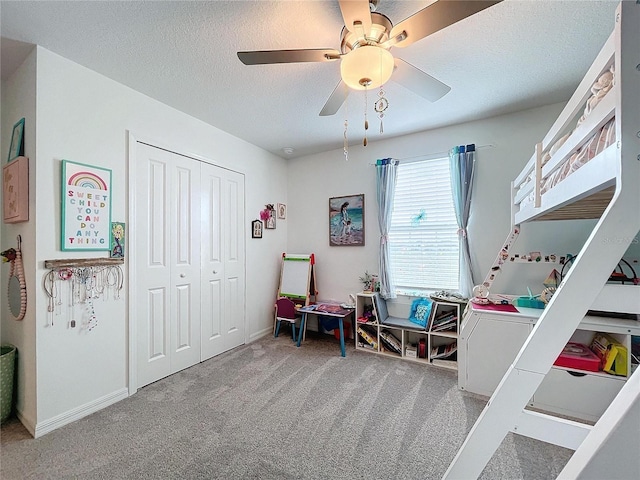 bedroom with carpet, a textured ceiling, a closet, and ceiling fan