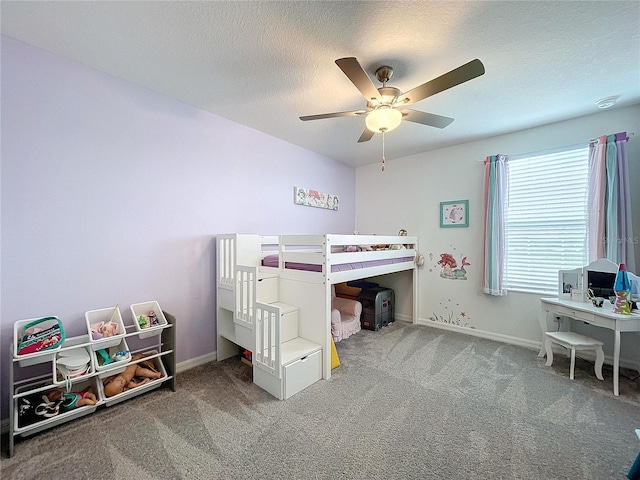 bedroom featuring ceiling fan, carpet floors, and a textured ceiling