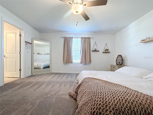 carpeted bedroom with ceiling fan and a textured ceiling