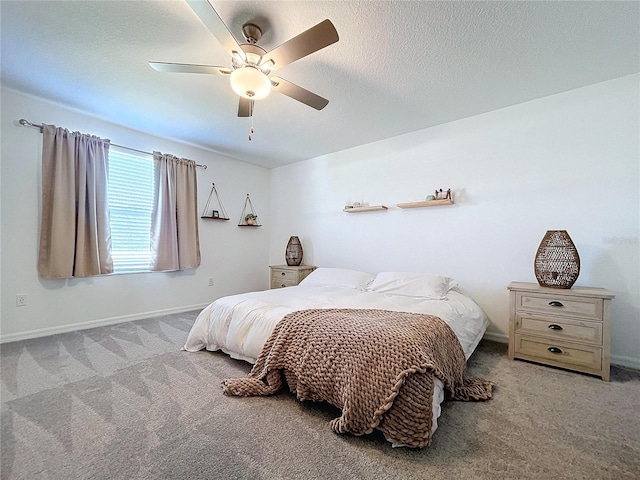 bedroom featuring ceiling fan, light colored carpet, and a textured ceiling