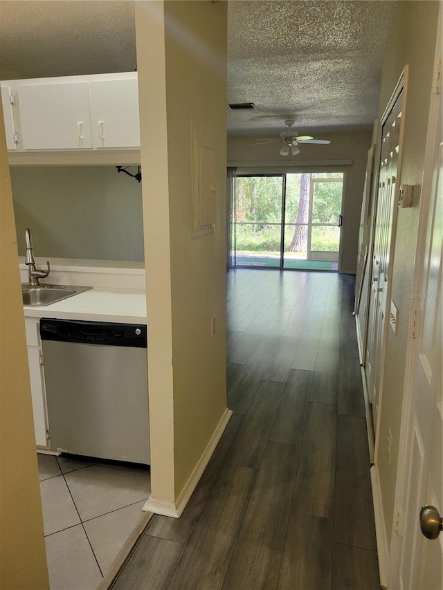 hall featuring sink, wood-type flooring, and a textured ceiling