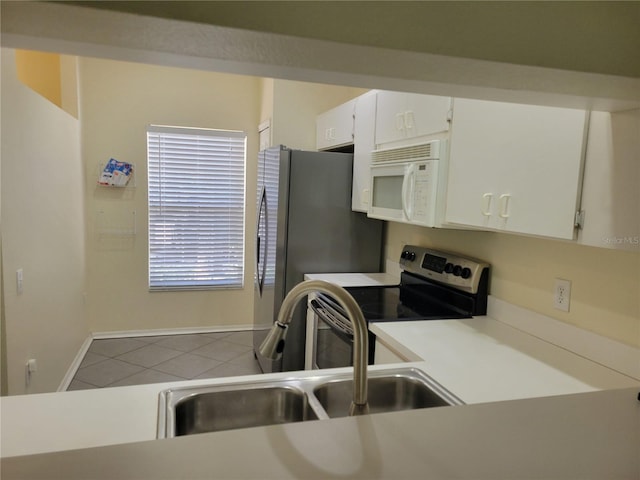 kitchen with white cabinetry, sink, tile patterned floors, and stainless steel appliances