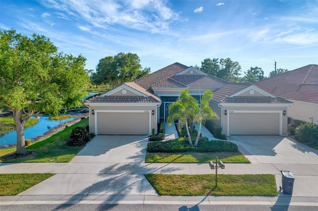 view of front of home with a garage and a front lawn