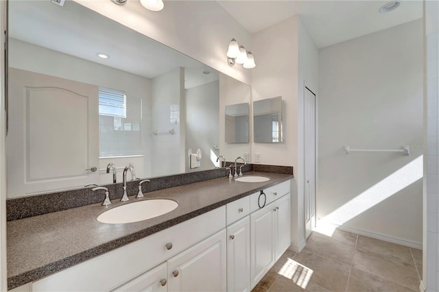 bathroom featuring walk in shower, tile patterned flooring, and vanity