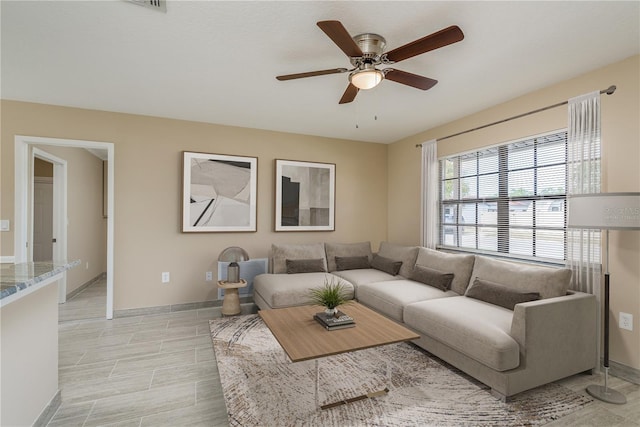 living room with light wood-type flooring and ceiling fan