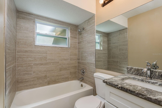 full bathroom with toilet, vanity, tiled shower / bath, and plenty of natural light