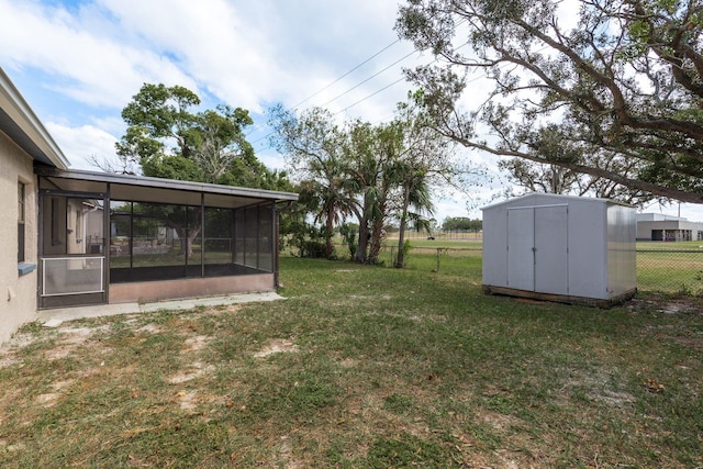 view of yard with a sunroom and a shed