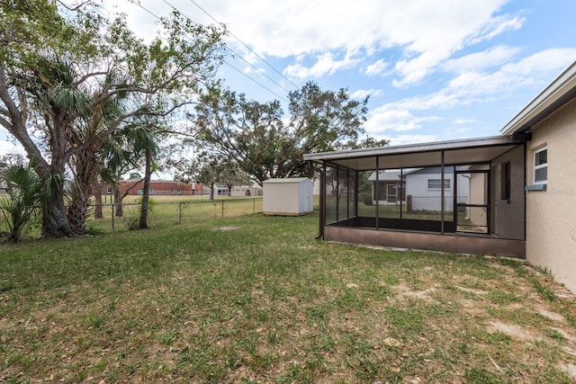 view of yard featuring a sunroom and a storage shed