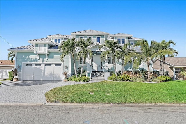 view of front of home with a front yard and a garage