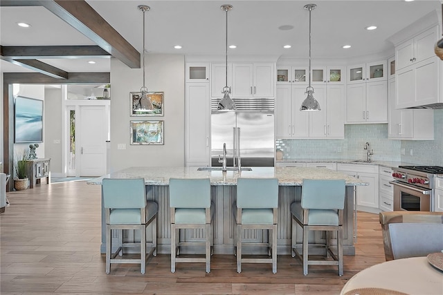 kitchen with beam ceiling, a spacious island, and high end appliances