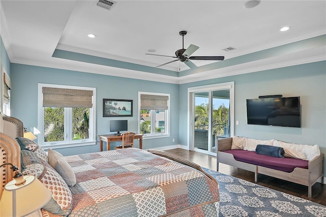 bedroom with a tray ceiling, access to exterior, ceiling fan, and dark wood-type flooring