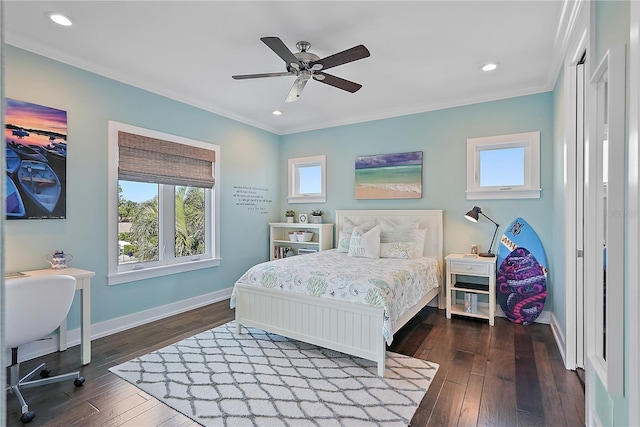 bedroom with ornamental molding, ceiling fan, and dark wood-type flooring