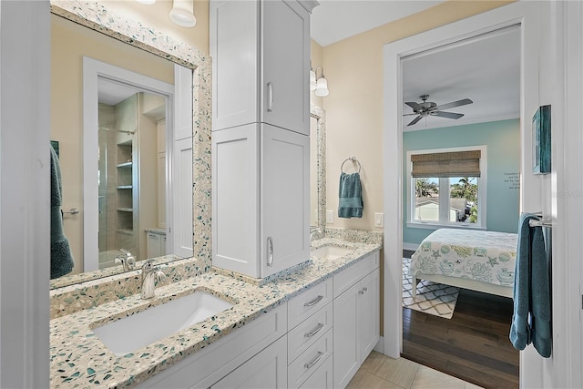 bathroom featuring ceiling fan, vanity, and wood-type flooring