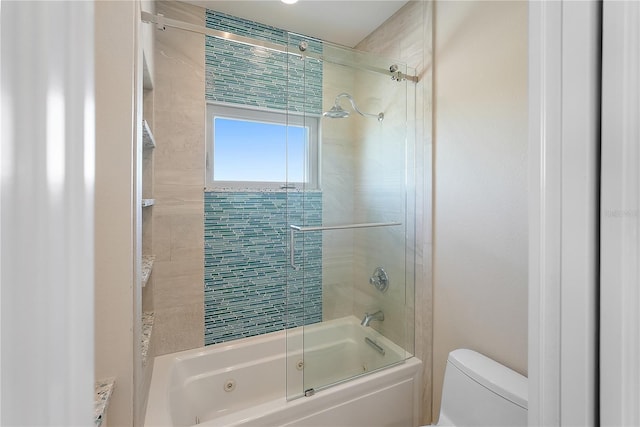 bathroom featuring enclosed tub / shower combo and toilet