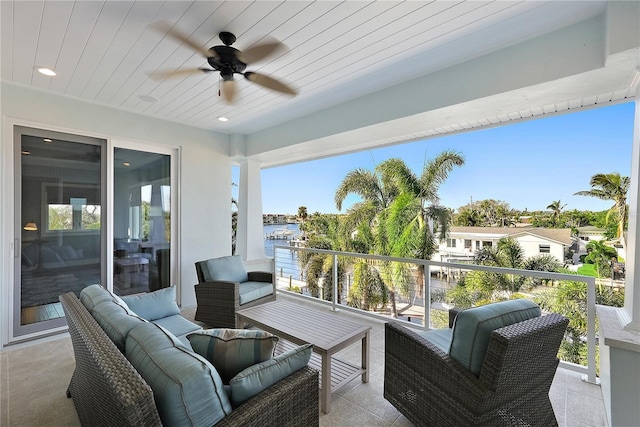 sunroom featuring plenty of natural light, ceiling fan, and wood ceiling