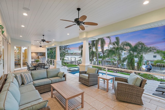 patio terrace at dusk with ceiling fan and an outdoor hangout area