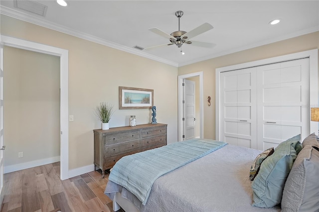 bedroom featuring crown molding, ceiling fan, a closet, and light hardwood / wood-style floors