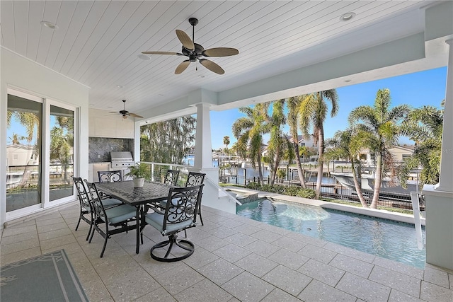 view of patio / terrace with a water view, area for grilling, and a grill