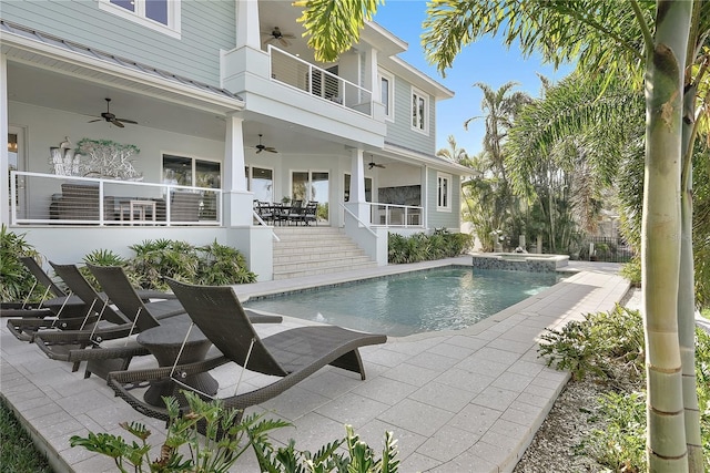 view of swimming pool featuring ceiling fan and a patio