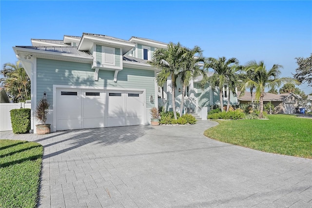 view of front facade with a front yard and a garage