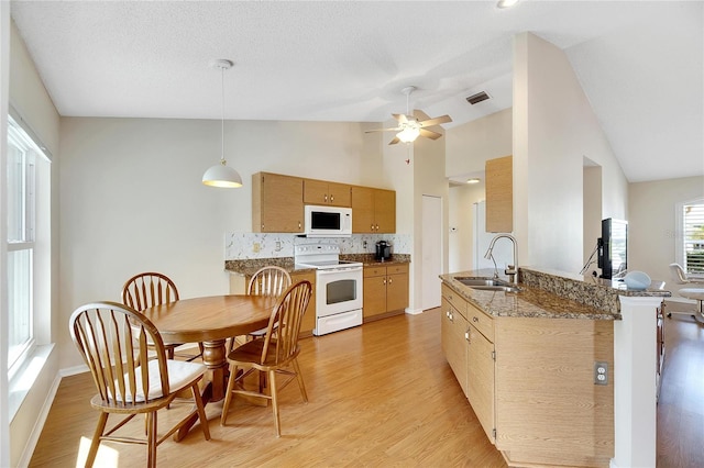 kitchen with kitchen peninsula, sink, ceiling fan, light hardwood / wood-style flooring, and white appliances