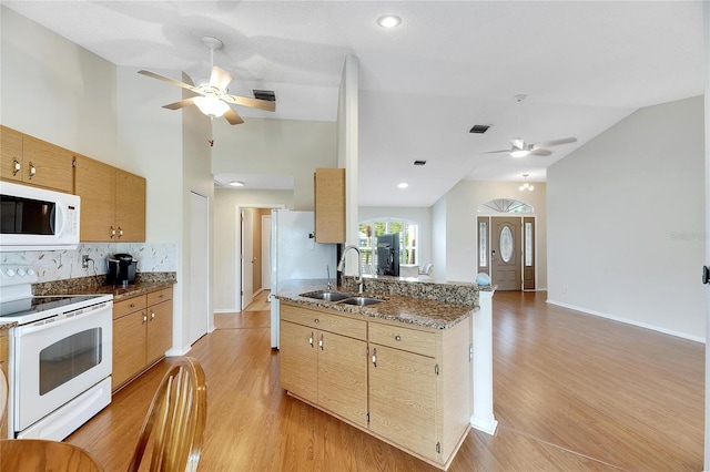 kitchen featuring light wood-type flooring, sink, white appliances, and backsplash