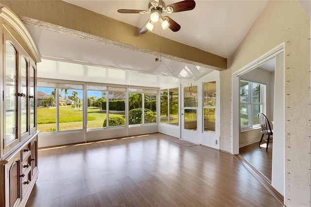 unfurnished sunroom featuring ceiling fan and vaulted ceiling