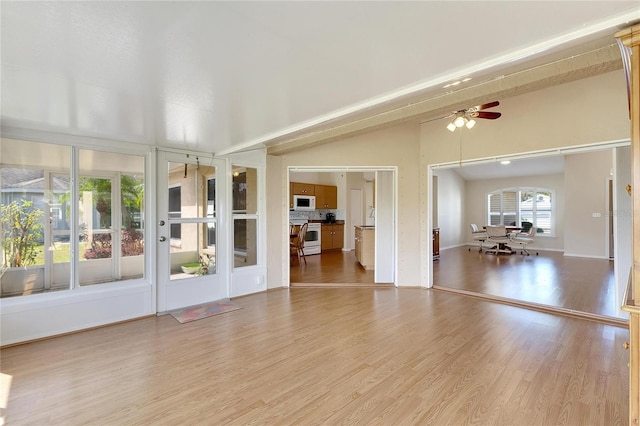 interior space with lofted ceiling, hardwood / wood-style floors, and ceiling fan