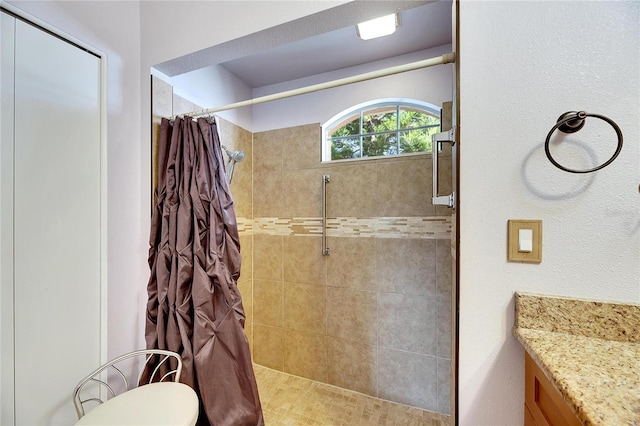 bathroom with walk in shower and vanity