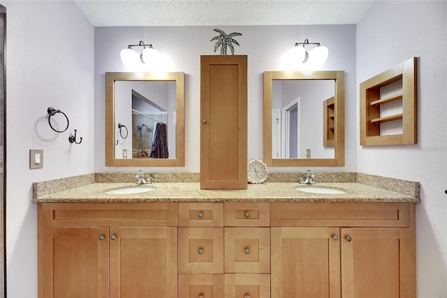 bathroom featuring vanity and a textured ceiling