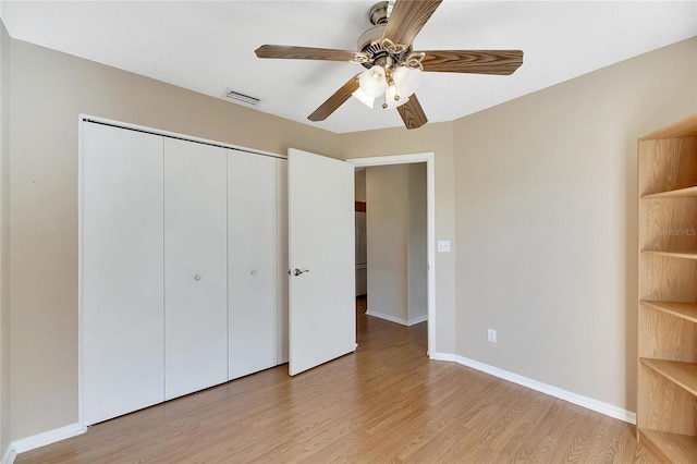 719 Winterbrooke Way, Sun City Center, FL 33573 - unfurnished bedroom with light wood-style floors, a closet, baseboards, and ceiling fan