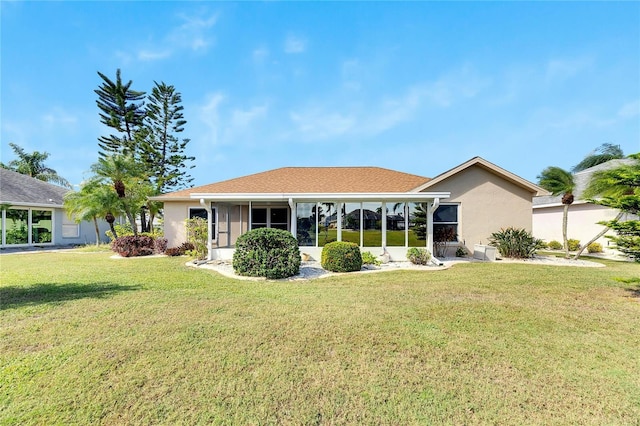 719 Winterbrooke Way, Sun City Center, FL 33573 - back of house featuring a sunroom, a yard, and stucco siding