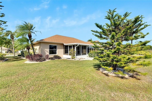 719 Winterbrooke Way, Sun City Center, FL 33573 - rear view of house with a sunroom, a lawn, and stucco siding