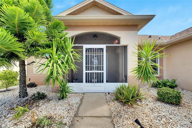 719 Winterbrooke Way, Sun City Center, FL 33573 - view of exterior entry featuring stucco siding